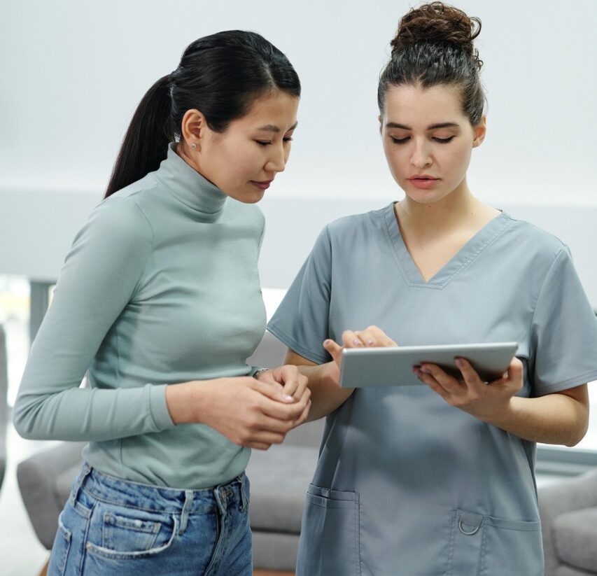 young woman consulting nurse about pregnancy options